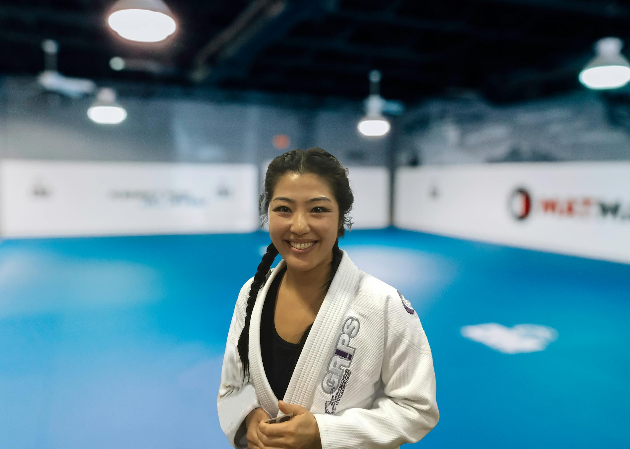 Haley Kim standing on the mats at Kenny Kim Brazilian Jiu Jitsu in Marietta GA