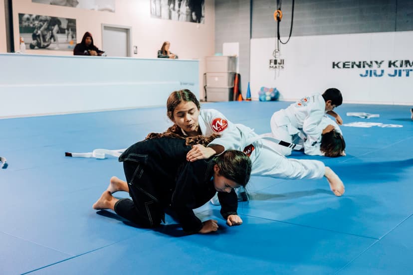 Brazilian Jiu Jitsu Kids at Kenny Kim BJJ in Marietta GA rolling and practicing techniques in class
