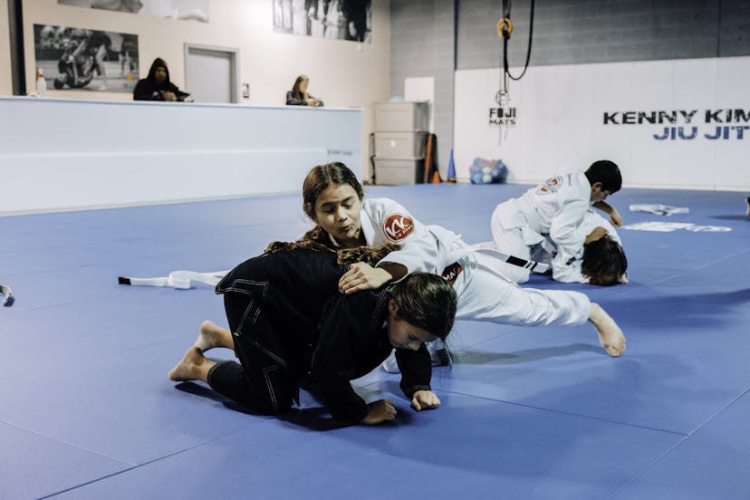 Brazilian Jiu Jitsu Kids at Kenny Kim BJJ in Marietta GA rolling and practicing techniques in class