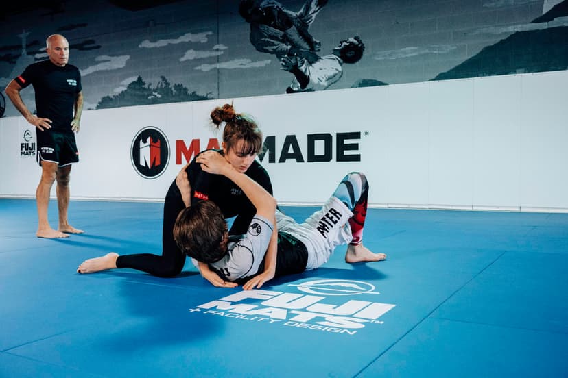 Brazilian Jiu Jitsu Teenagers at Kenny Kim BJJ in Marietta GA rolling on the mats girl vs boy instructor waiting closeby